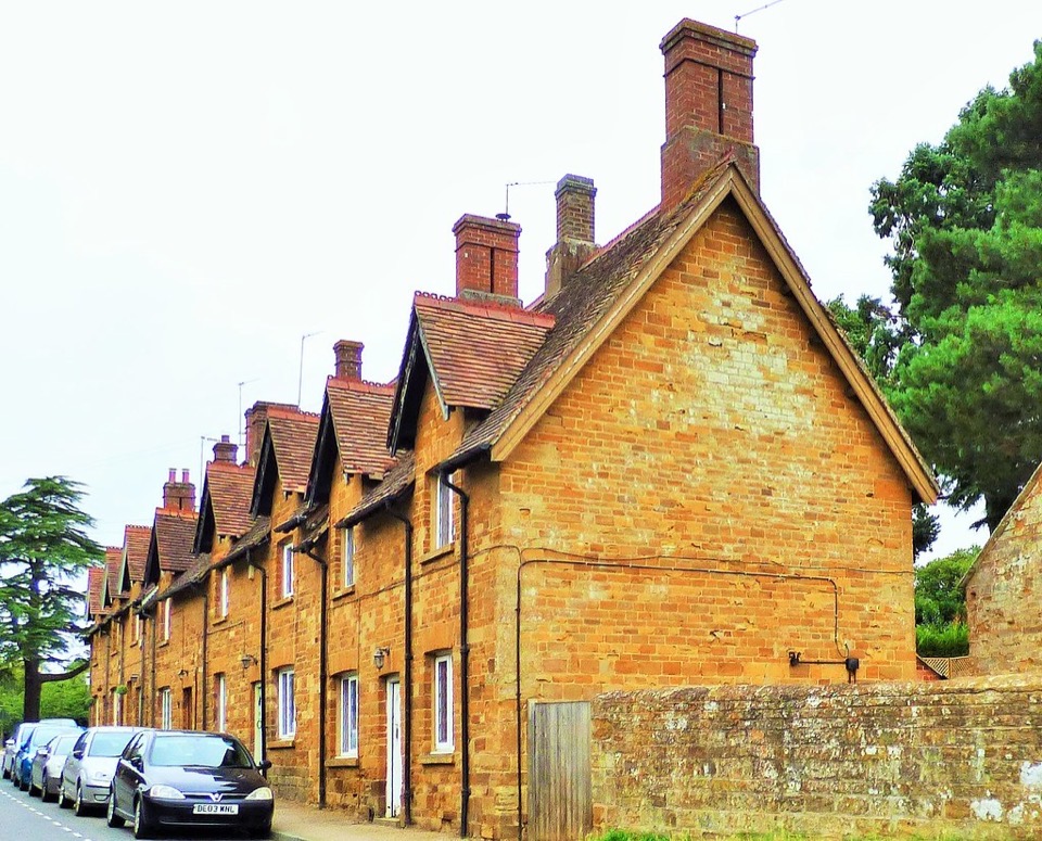 A terrace of golden ironstone cottages with dormer windows at Husbands Bosworth in Leicestershire