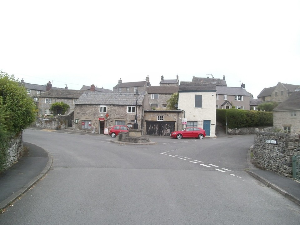 Limestone cottages and a village post office beside a road junction at Calver in Derbyshire